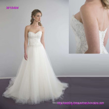 Elegant Strapless Wedding Dress with a Fitted Bodice Decorated with a Beaded Italian Lace and a Full Skirt Made From Layers of Dreamy Tulle and Organza